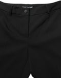 Pantalon Dolce & Gabbana noir à taille haute et coupe droite, en tissu élégant, porté comme pantalon de costume ou de soirée.