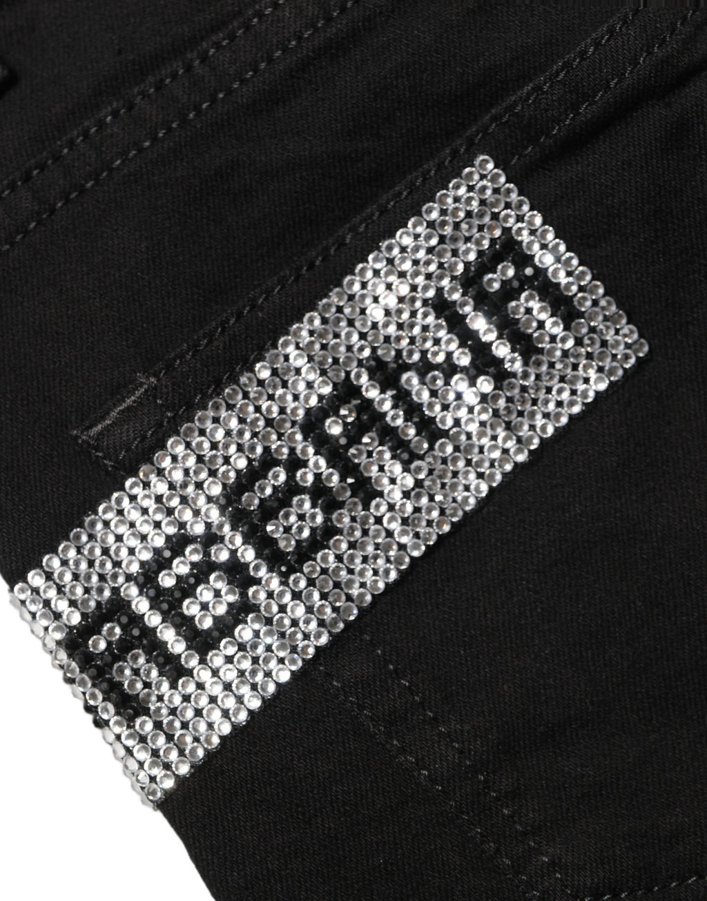 Jeans en denim noir Dolce & Gabbana Grace à taille haute avec strass, visible en gros plan sur l’image.