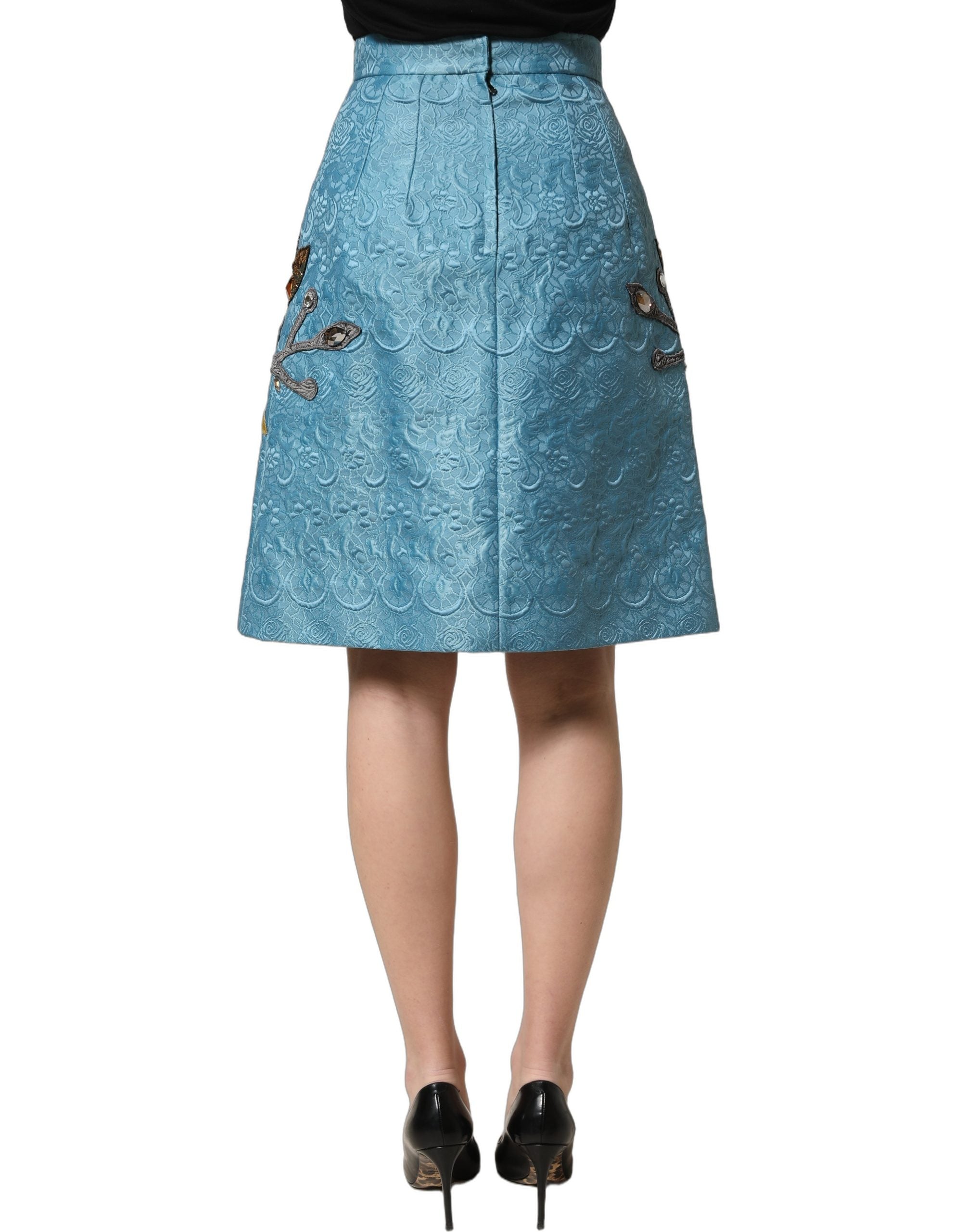 Jupe en jacquard bleu Dolce & Gabbana à coupe évasée avec broderies élégantes, conçue pour un style sophistiqué et féminin.