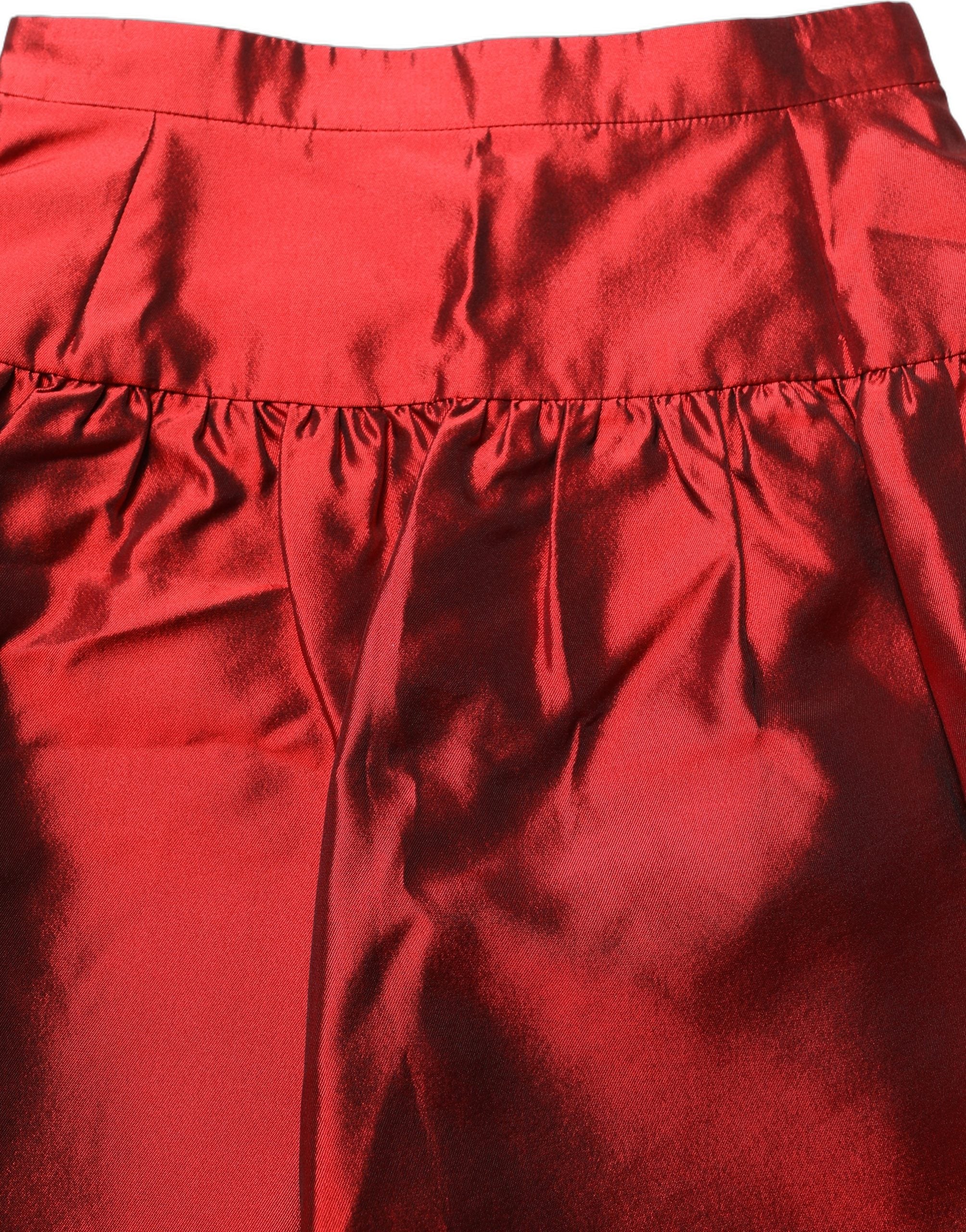 Mini jupe en satin de soie rouge à taille haute et en bulle, signée Dolce & Gabbana, visible avec détails élégants.