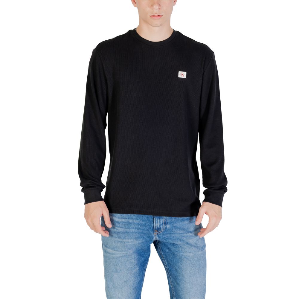 T-shirt à manches longues en coton noir de la marque Calvin Klein Jeans, coupe classique et logo discret sur la poitrine.
