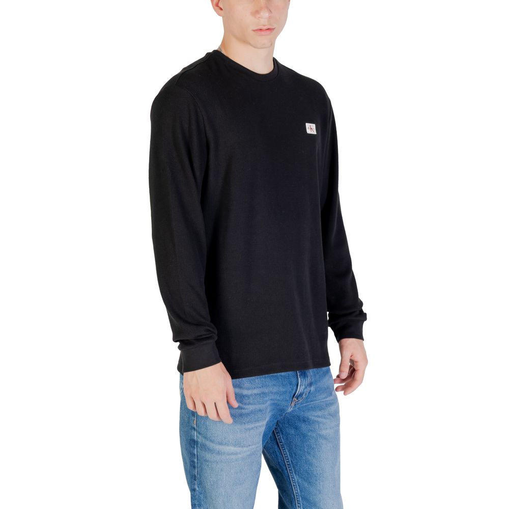 T-shirt à manches longues en coton noir de Calvin Klein Jeans, coupe classique et logo discret sur la poitrine.