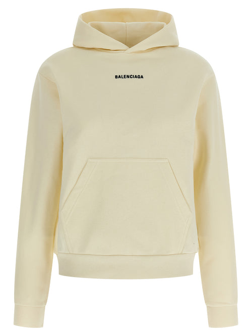 Sweat-shirt beige en coton de la marque Balenciaga, coupe décontractée et logo discret visible sur l'image.