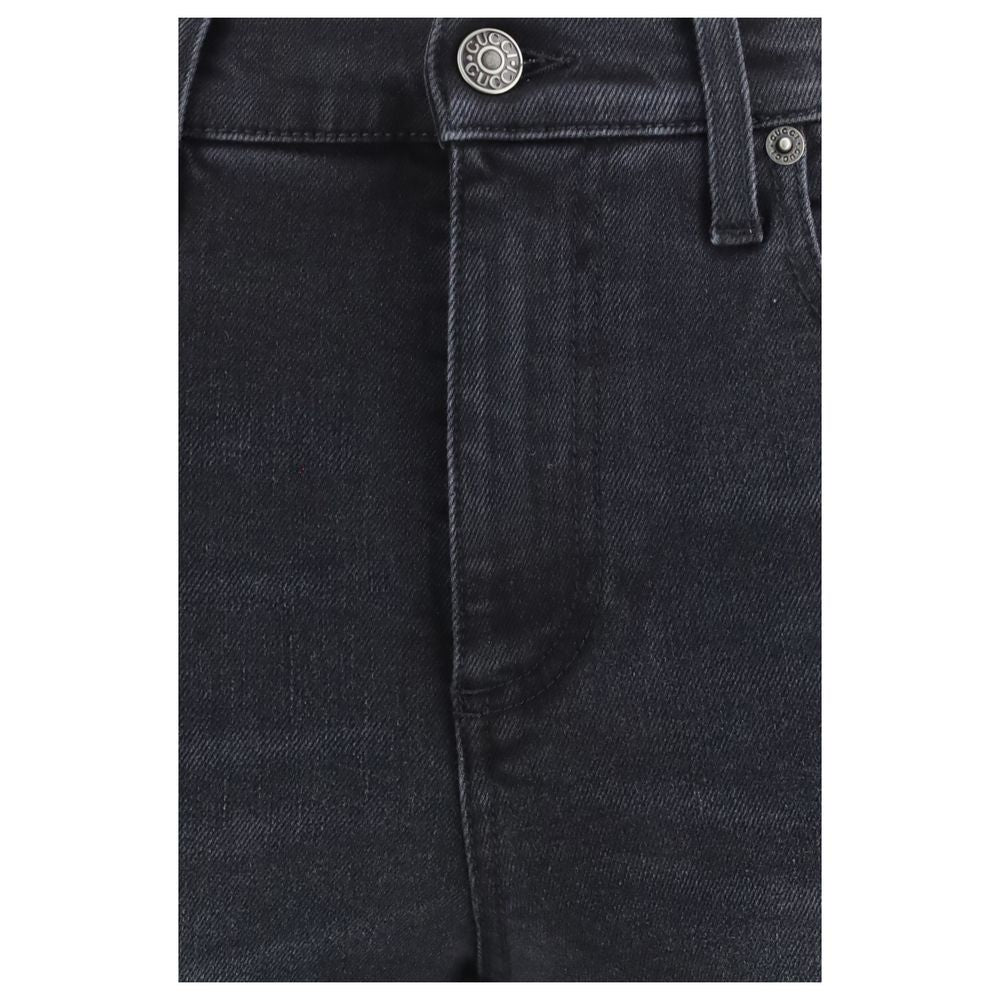 Jeans skinny en coton noir de Gucci, coupe ajustée et style élégant, visibles sur l'image.