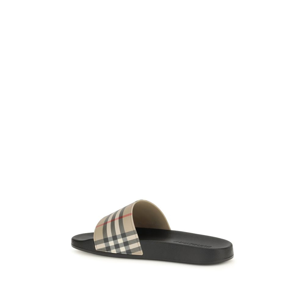 Sandales en caoutchouc noires Burberry, modernes et confortables, avec logo emblématique, pour un style décontracté.