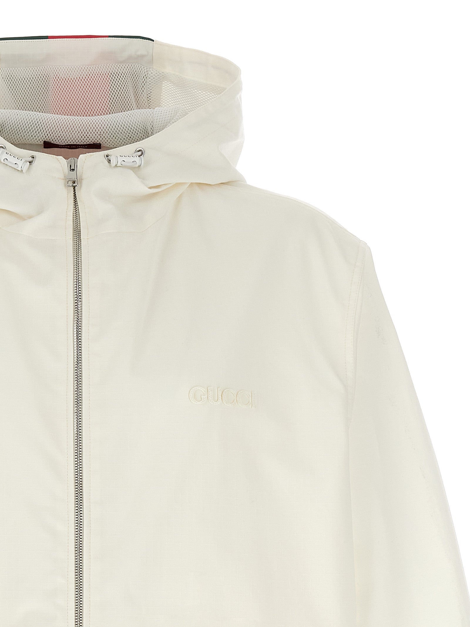 Veste en coton blanche Gucci pour hommes, coupe classique, avec détails de marque visibles sur la poitrine.