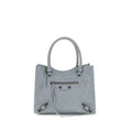 Sac à main Balenciaga en laine d'agneau bleue, design élégant avec détails sophistiqués, porté ou posé sur une surface.