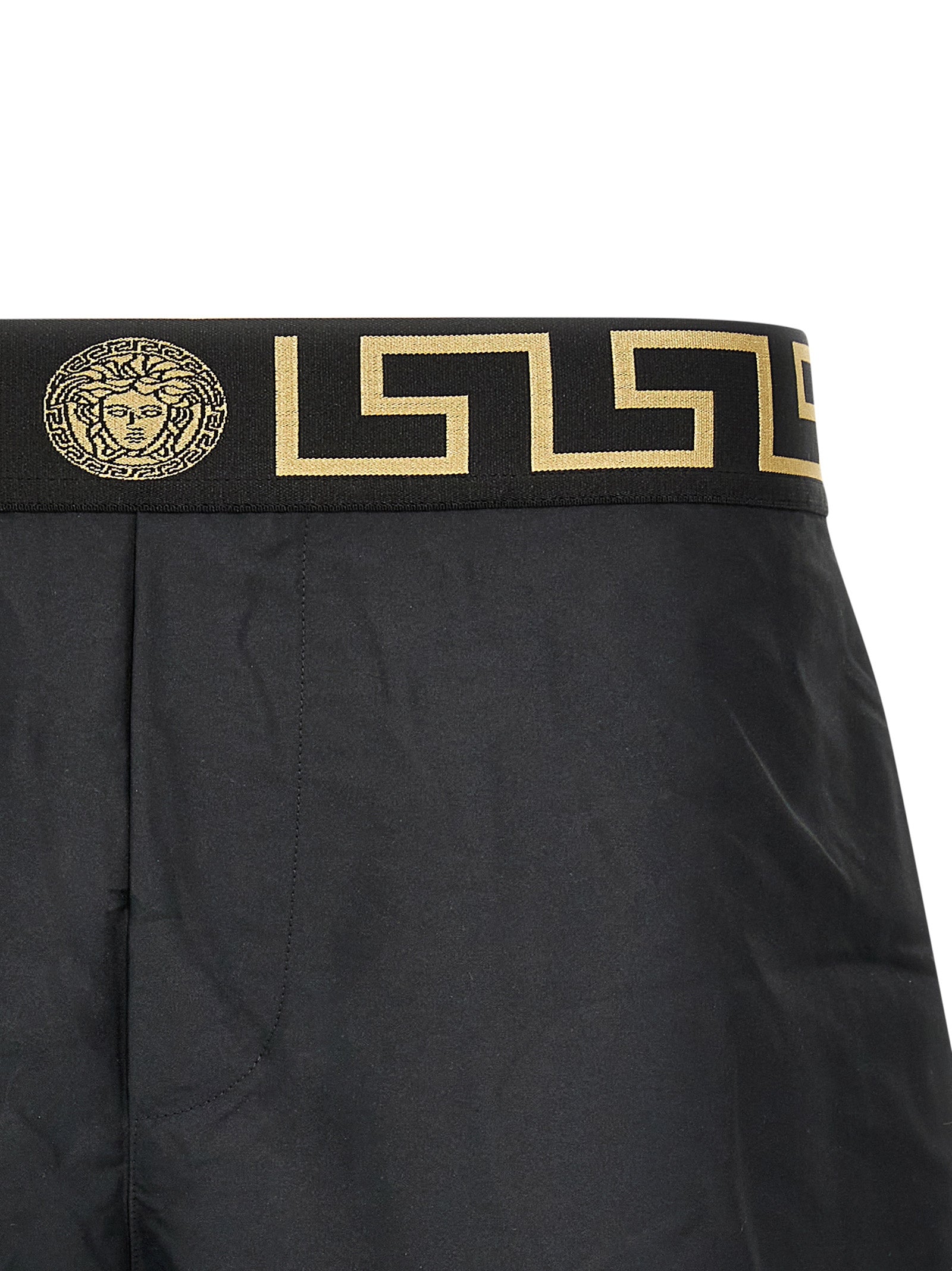 Shorts de bain multicolores en polyester de la marque Versace, avec motif coloré et logo visible.