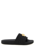 Sandales en verre noir Versace avec logo emblématique, glissières élégantes pour un style sophistiqué et confortable.