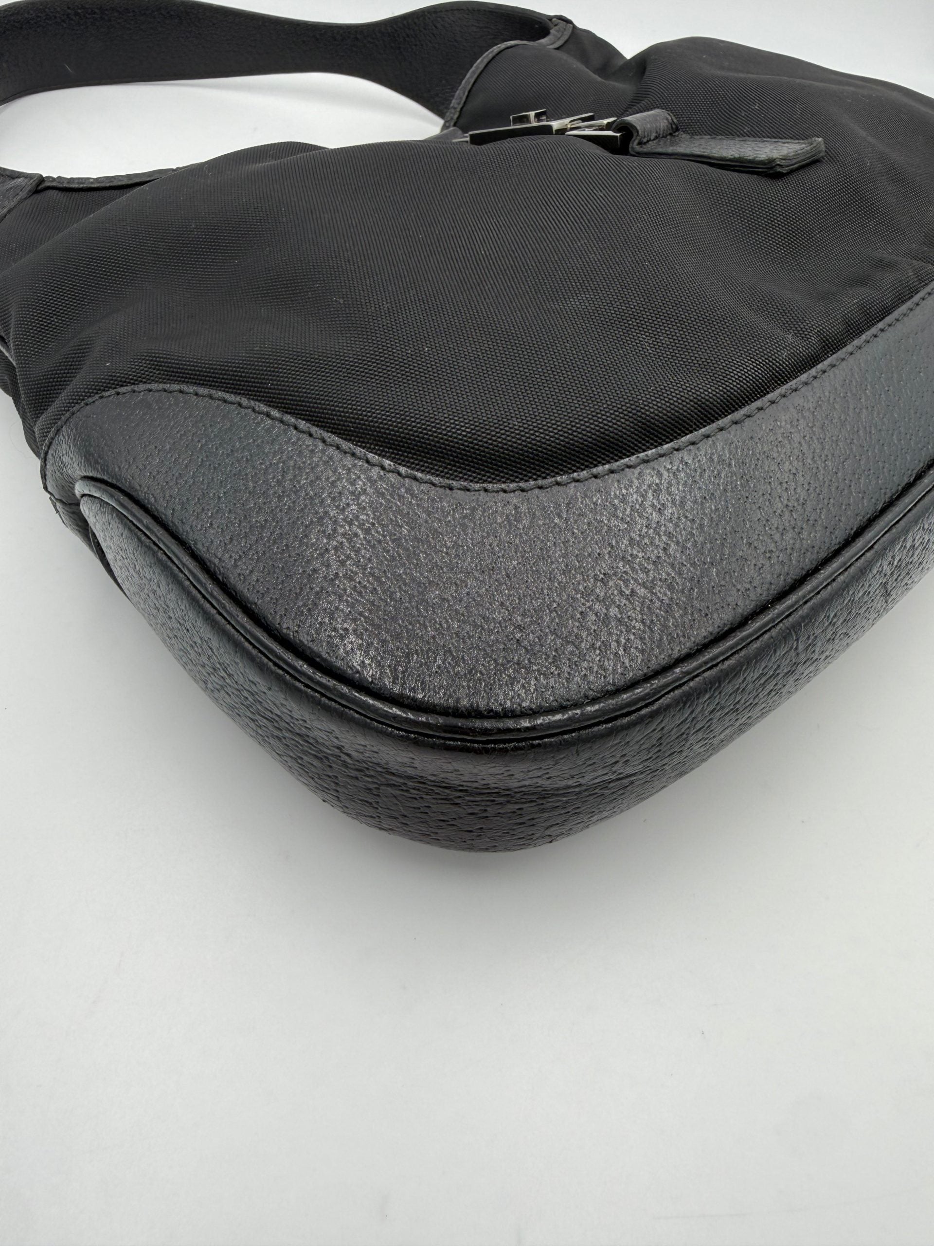 Sac à main Gucci Jackie en cuir et toile, avec bandoulière et détails élégants, vue de face.