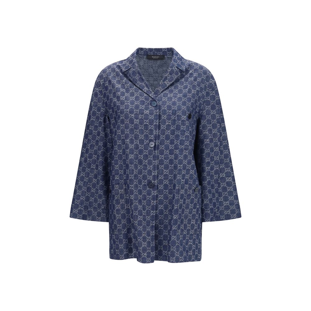 Veste longue en coton bleue de Gucci, style élégant, avec détails de marque visibles, portée sur un mannequin.