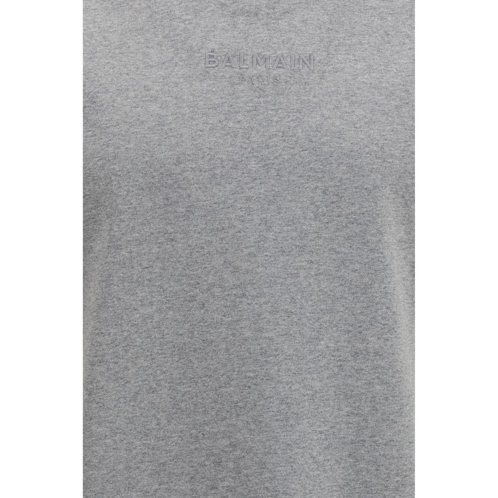 T-shirt gris en coton de la marque Balmain, coupe classique avec logo visible sur le devant.