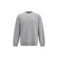 Sweat-shirt gris en coton de Balmain, style décontracté, avec logo discret, porté sur un modèle.