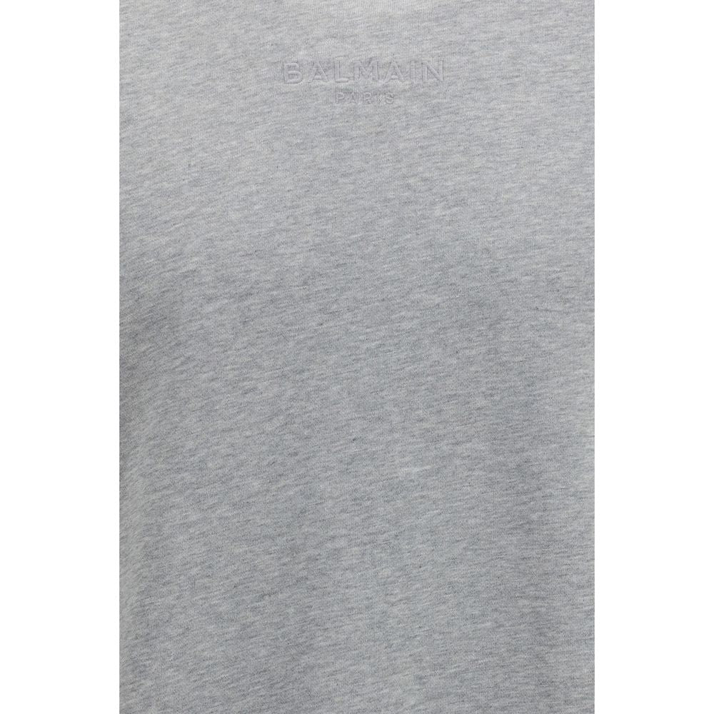 Sweatshirt gris en coton de la marque Balmain, coupe décontractée avec logo discret sur la poitrine, vue de face.