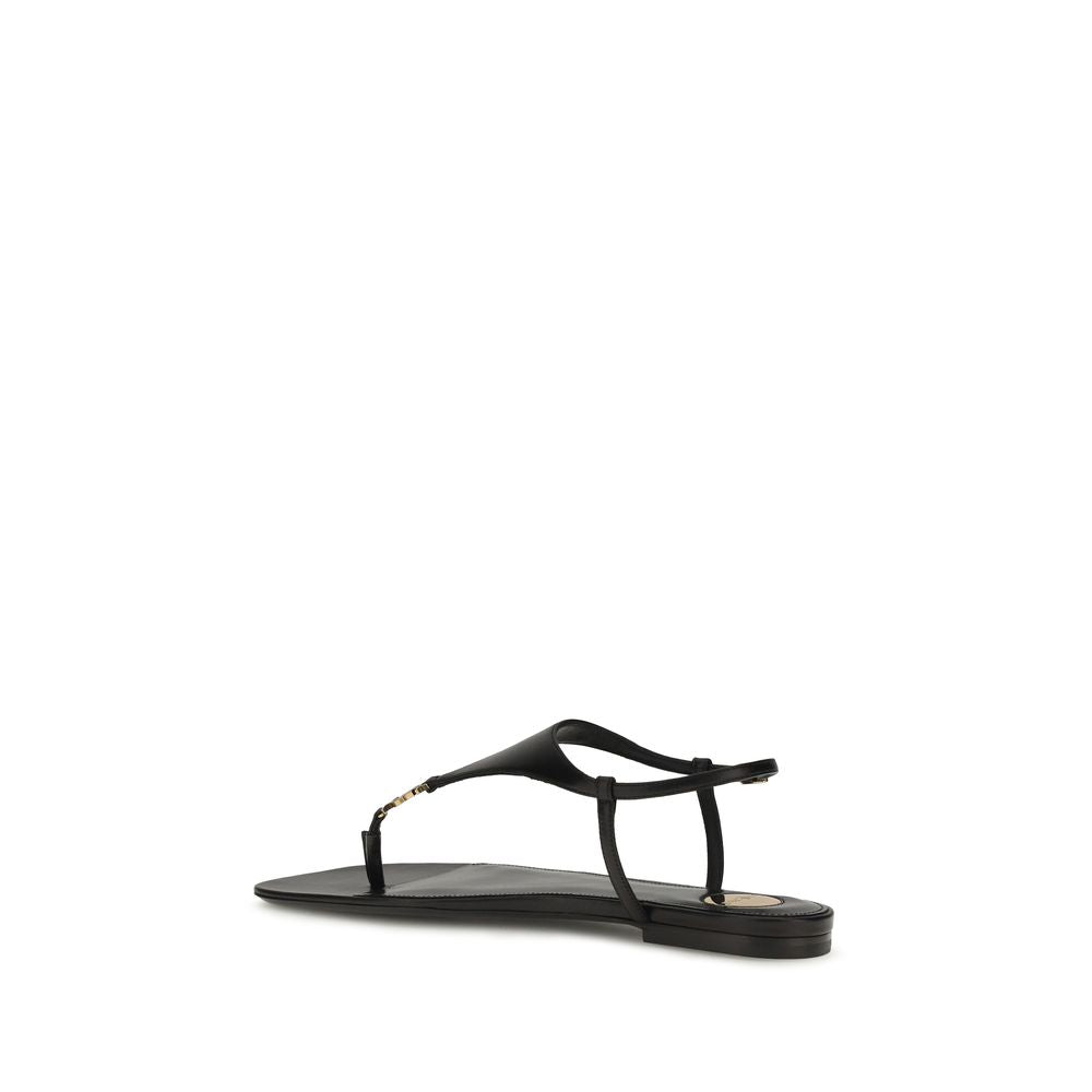 Sandales plates en cuir de veau noir de Saint Laurent Bos Taurus, avec design épuré et élégance moderne.