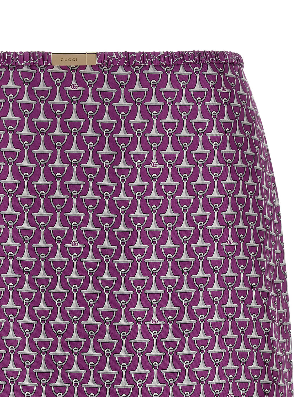 Jupe midi en soie violette Gucci, élégante et fluide, avec détail de couture visible dans l'image.
