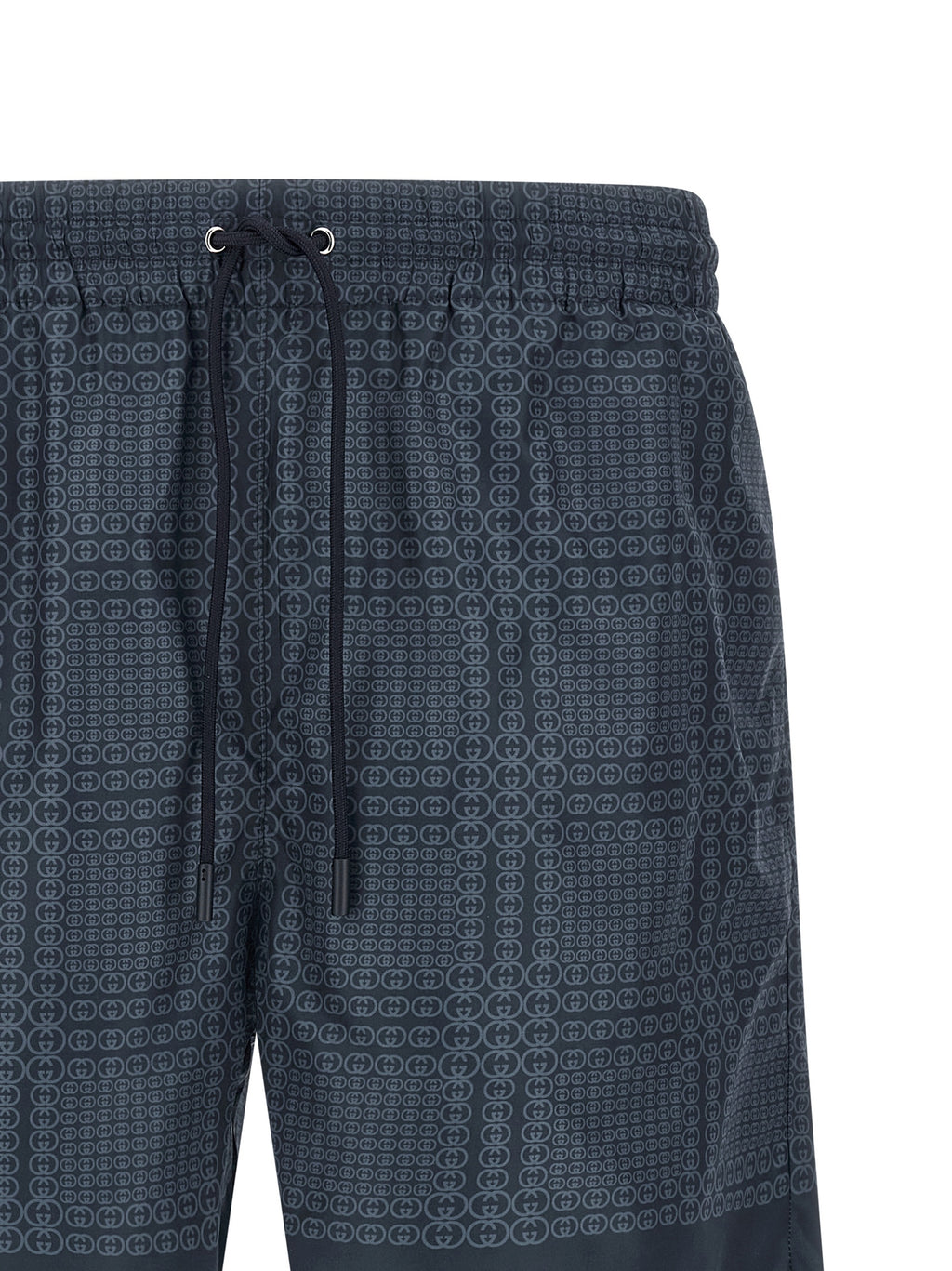 Shorts de bain en polyester bleu Gucci, vue de face, avec logo Gucci visible, parfait pour la plage ou la piscine.