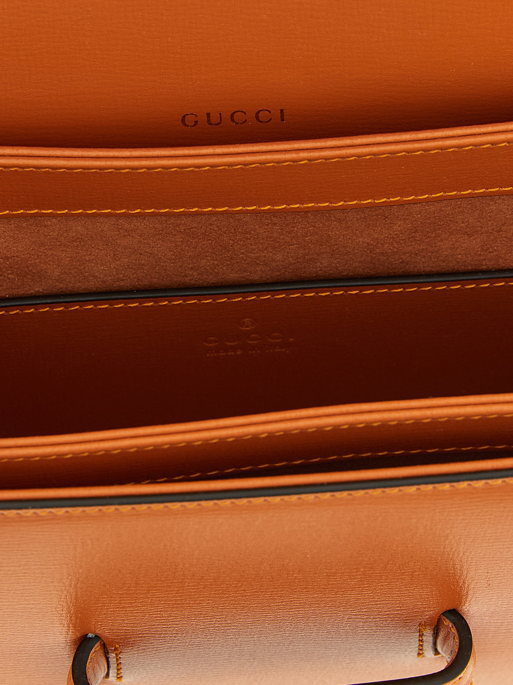 Sac à main Gucci en cuir de veau orange avec bandoulière, élégant et sophistiqué, visible avec détails de la marque.