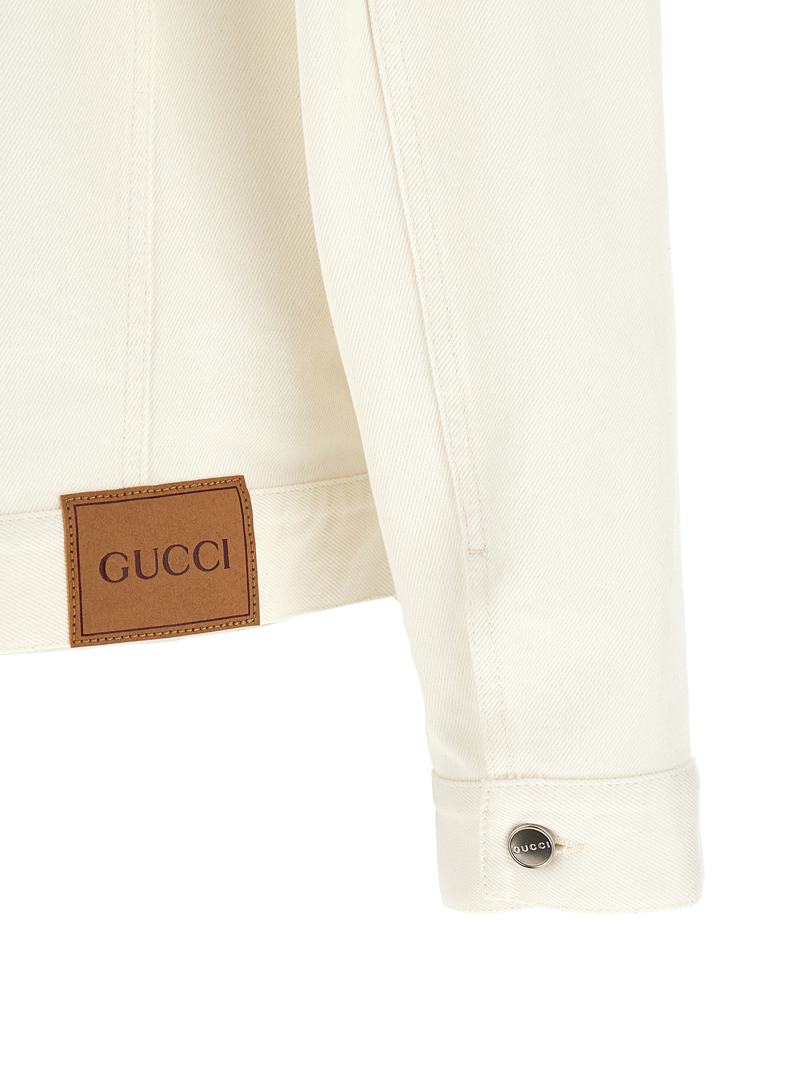 Veste en jean en coton blanc de Gucci, style décontracté, avec détails classiques et logo Gucci visible.