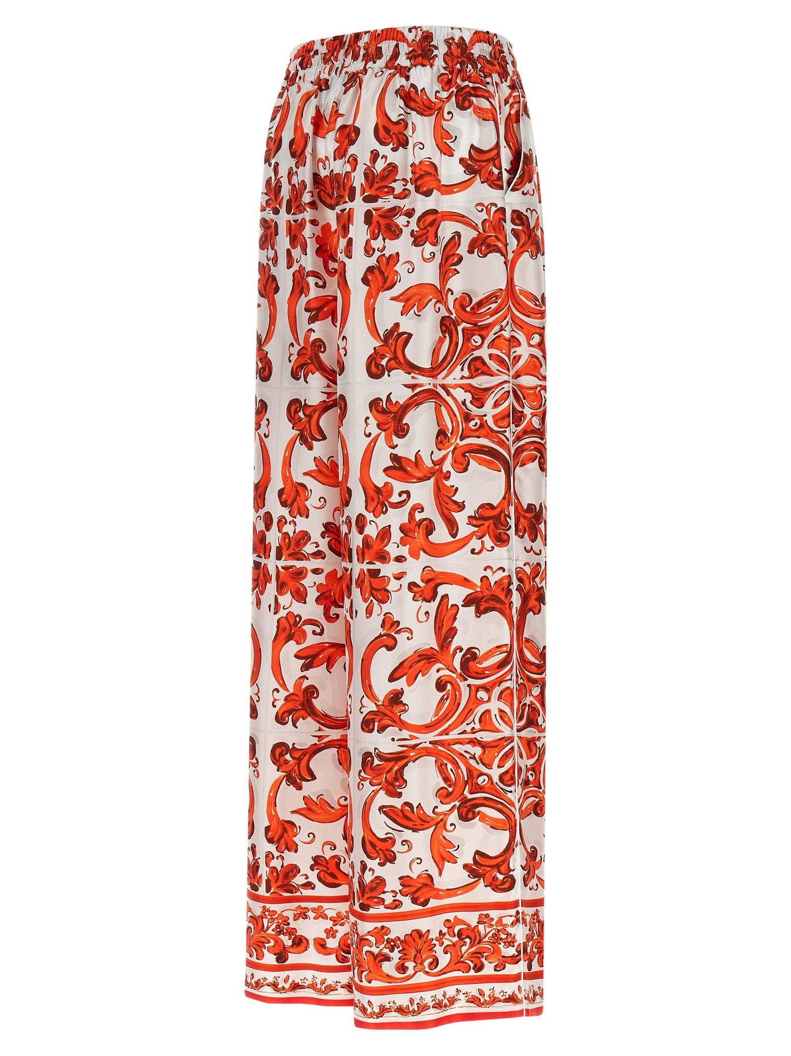 Pantalons évasés en soie orange de Dolce & Gabbana, vêtement chic pour femme, visible en détail sur l'image.