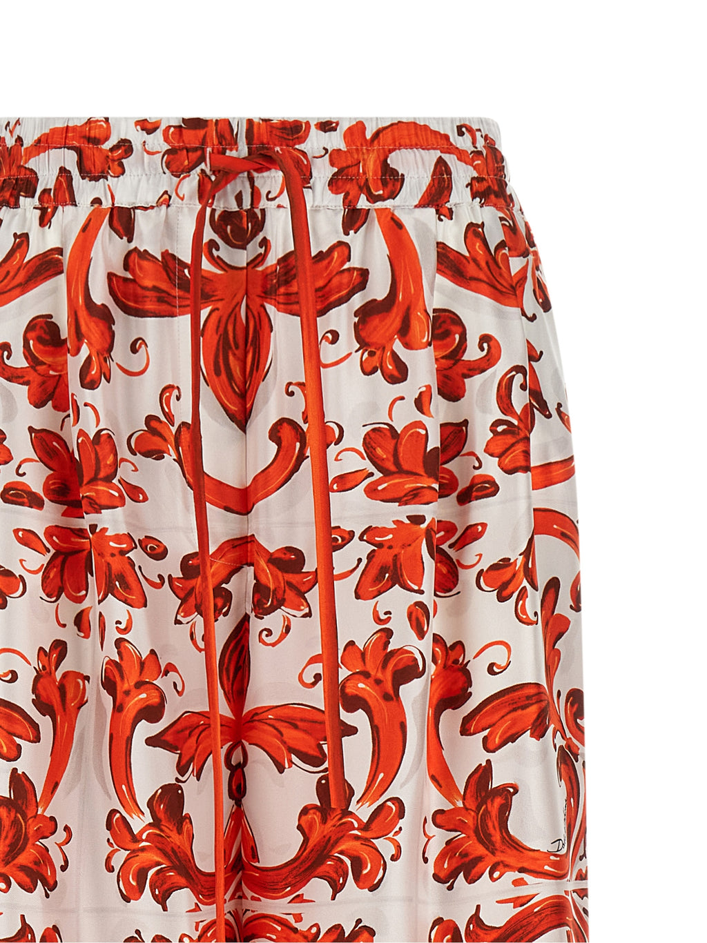 Pantalons évasés en soie orange de Dolce & Gabbana, vêtement élégant avec coupe fluide et détails sophistiqués.
