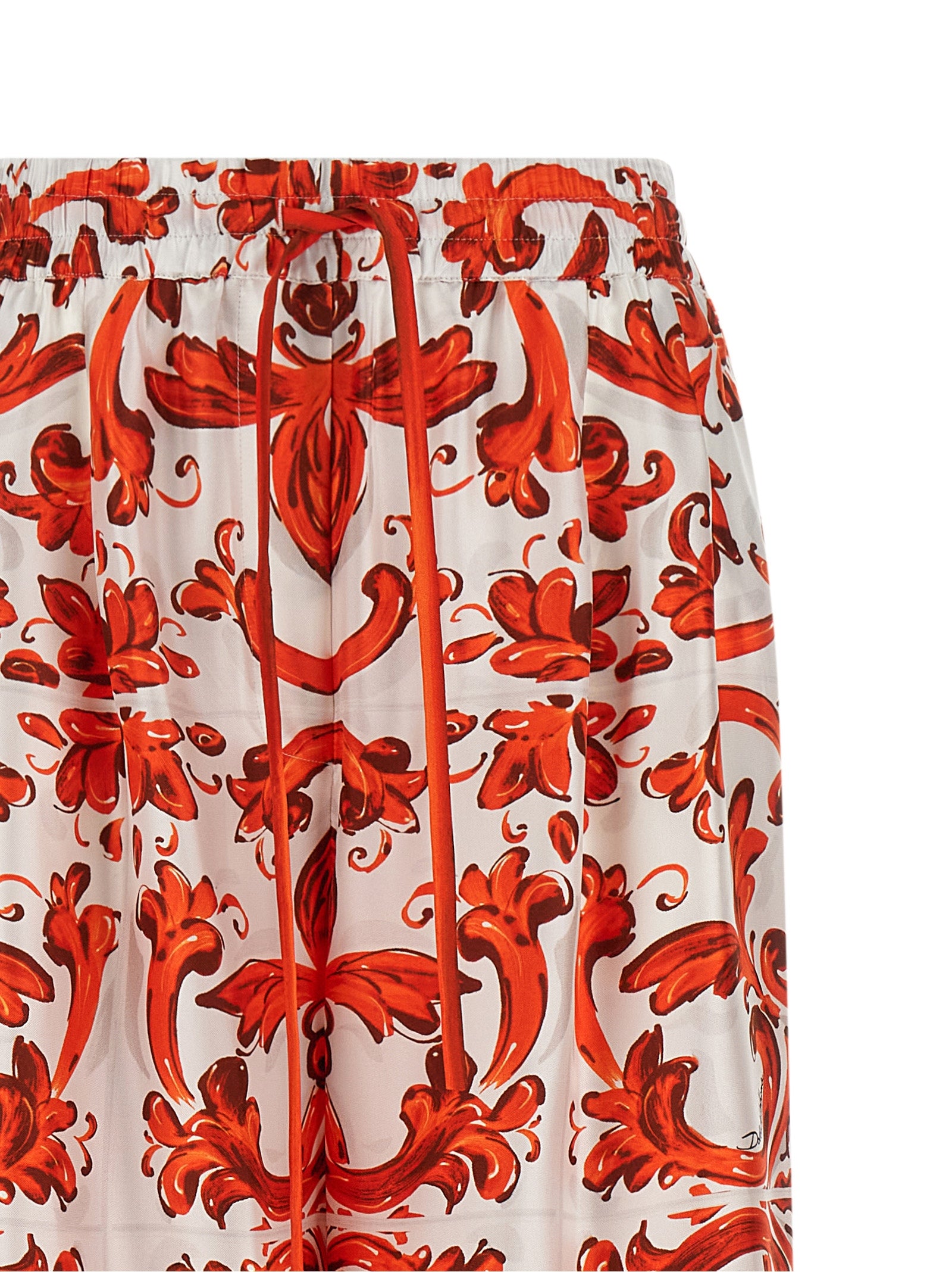Pantalons évasés en soie orange de Dolce & Gabbana, vêtement élégant avec coupe fluide et détails sophistiqués.