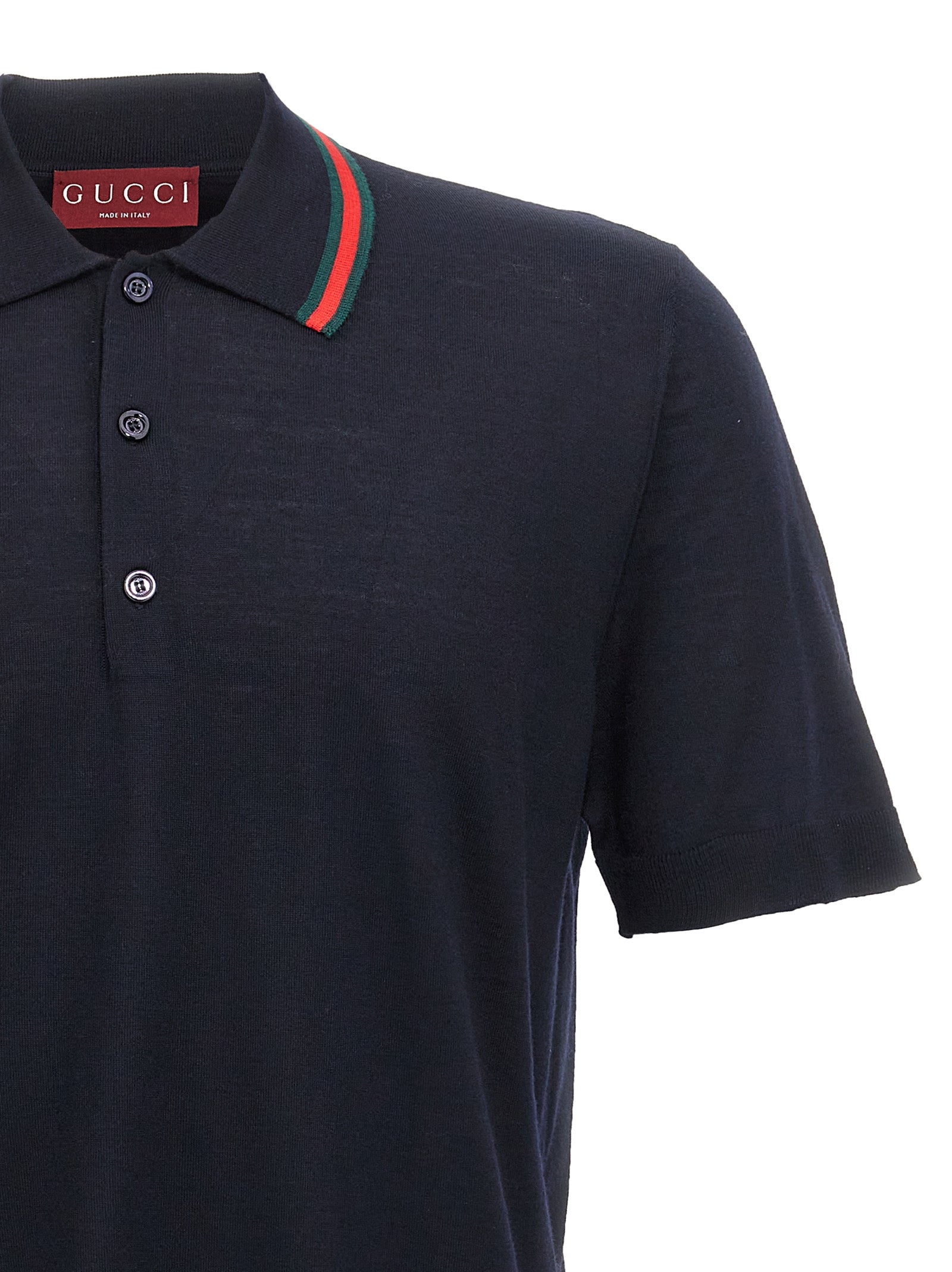 Chemise polo en laine bleue Gucci, vue de face, détails du col et du logo Gucci sur la poitrine.
