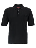 Chemise polo en laine noire Gucci, vue en détail, avec col et logo Gucci visible.