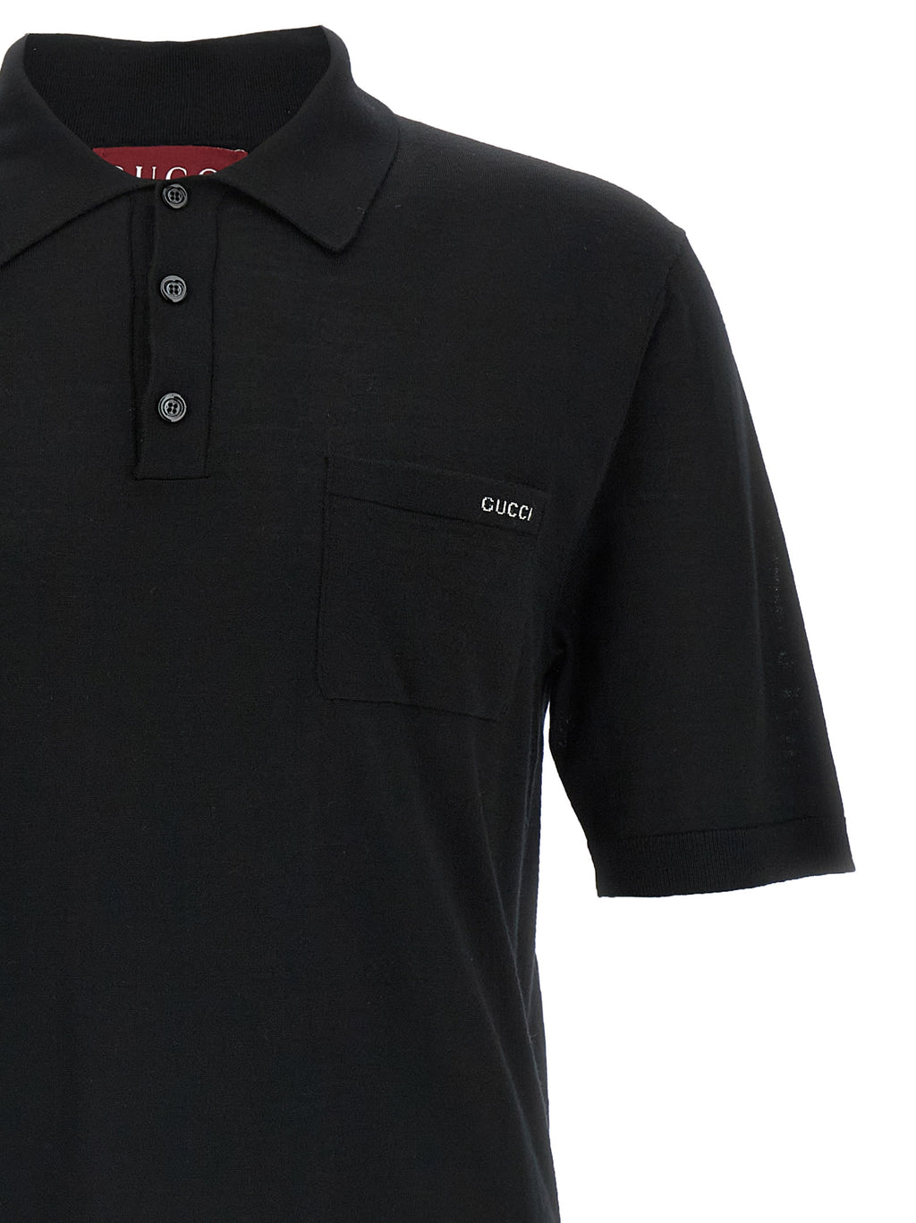 Chemise polo en laine noire Gucci, vue de face, détail du col et du logo Gucci sur la poitrine.
