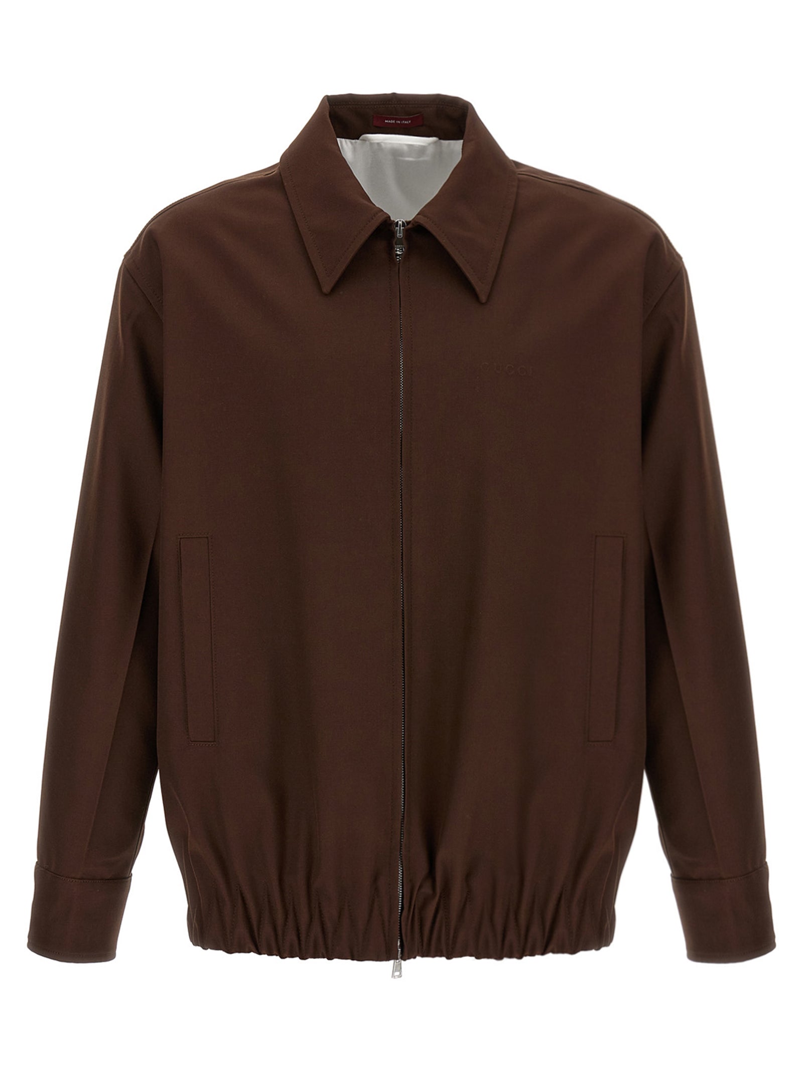 Veste longue en laine marron Gucci, coupe élégante avec détails sophistiqués, portée sur un mannequin.