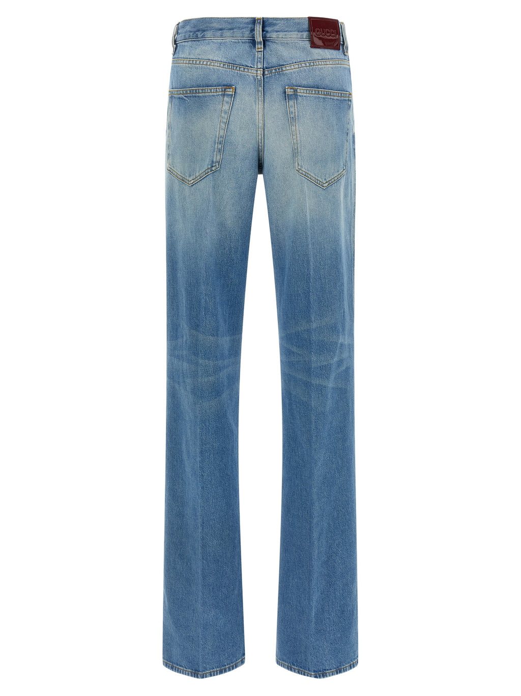 Jeans évasés en coton bleu Gucci, mode décontractée, détail du tissu et coupe flatteuse visible sur cette image.