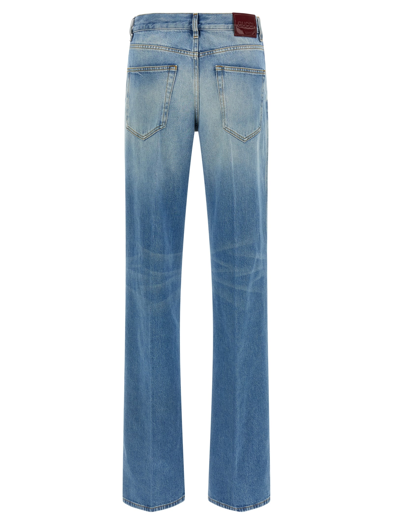 Jeans évasés en coton bleu Gucci, mode décontractée, détail du tissu et coupe flatteuse visible sur cette image.