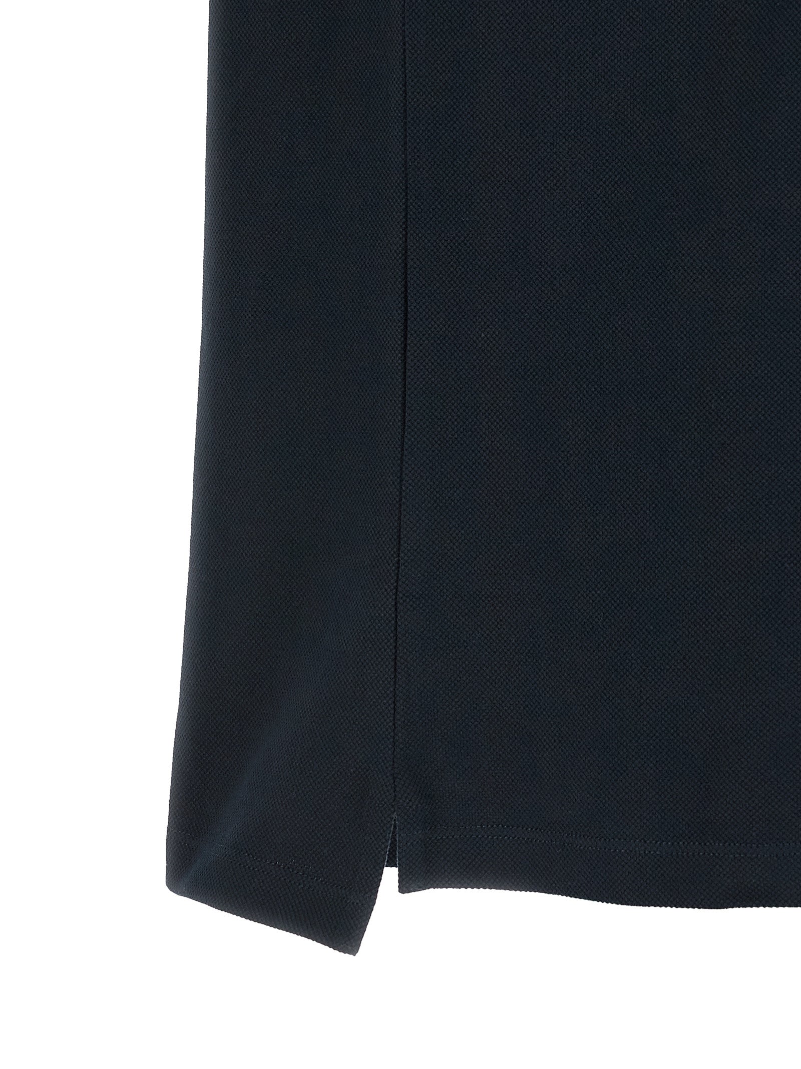 Chemise polo en coton bleu de Gucci, vue de face, avec col et logo distinctifs sur la poitrine.