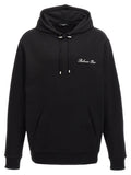 Sweat-shirt en coton noir de Balmain, style décontracté, avec logo discret sur la poitrine, porté sur un mannequin.