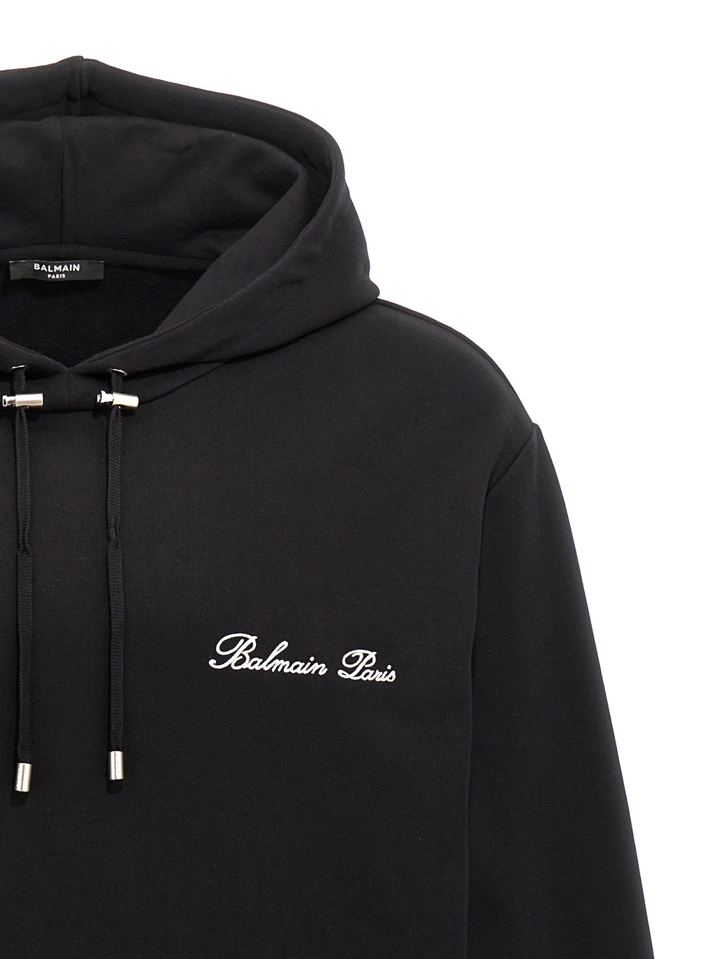 Sweatshirt en coton noir de Balmain, style décontracté avec logo discret, porté par un mannequin.
