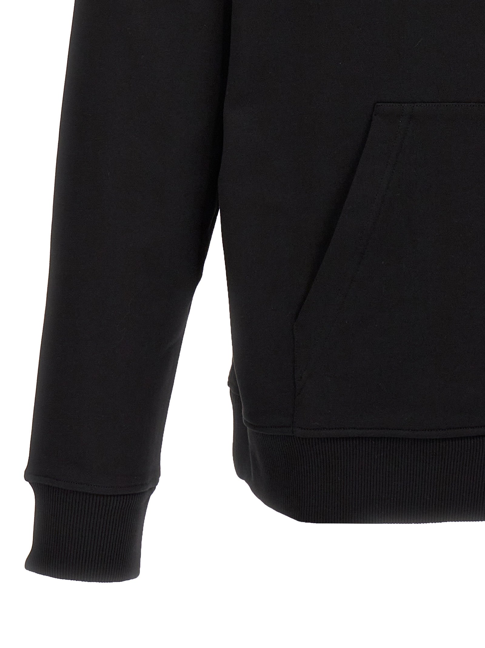 Sweat-shirt noir en coton de la marque Balmain, coupe décontractée avec logo discret, porté sur un mannequin.