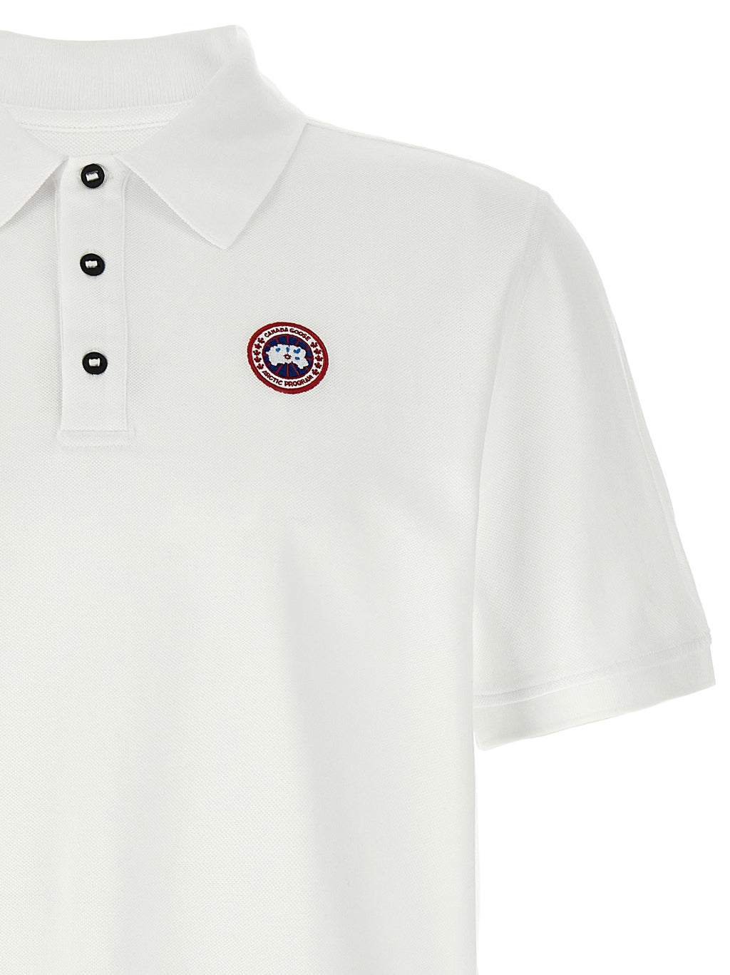 Chemise polo en coton blanche de Canada Goose, vue de face, avec col et boutons visibles.
