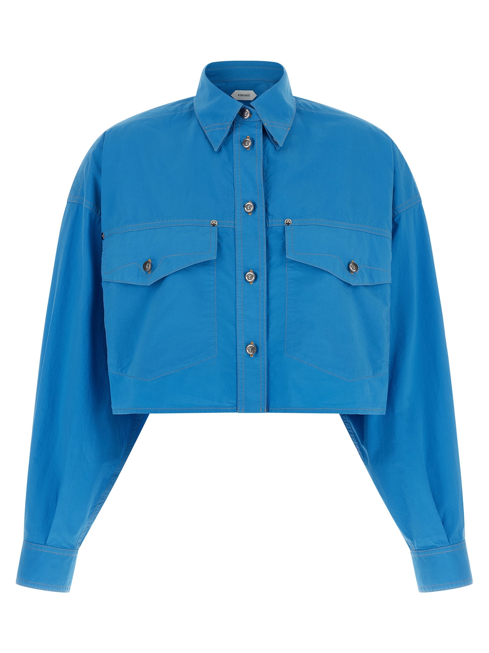 Blouse en coton bleue de la marque Versace, style élégant et sophistiqué, visible avec détails de la couture et du tissu.