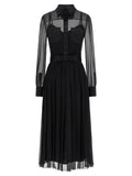 Robe midi en soie noire de Dolce & Gabbana, élégante et fluide, avec détails sophistiqués visibles sur l’image.