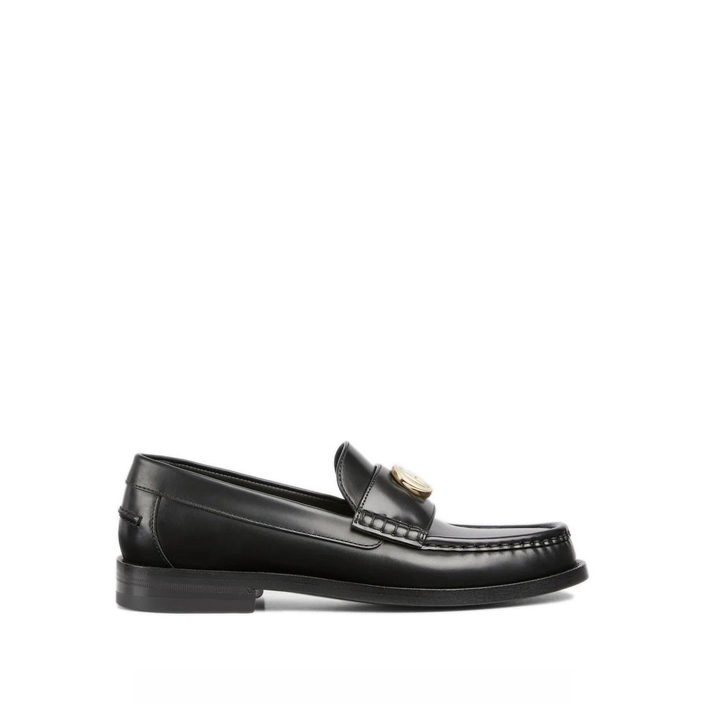 Mocassins Gucci en cuir noir pour homme, chaussons slip-on élégants avec finition soignée et semelle en cuir.