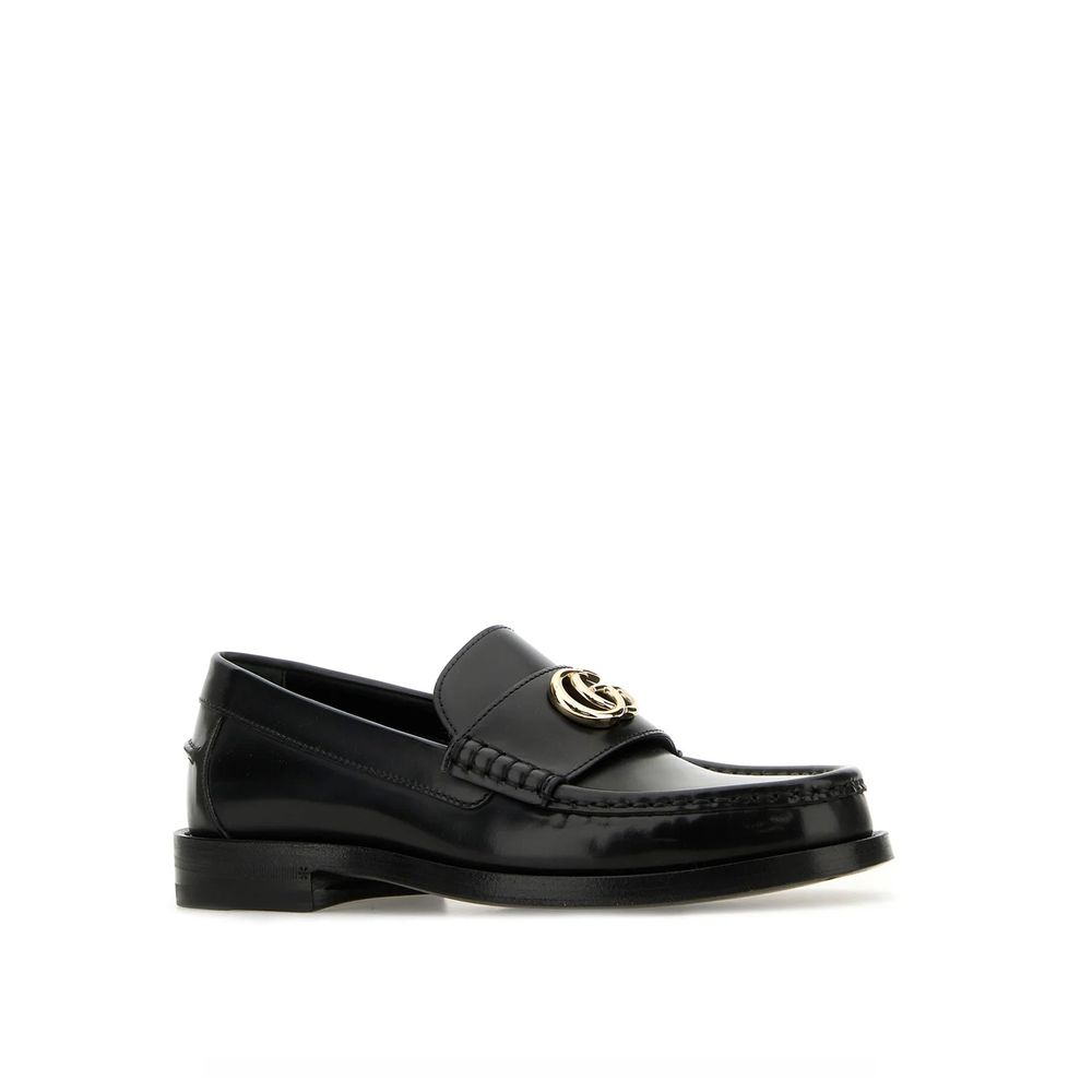 Mocassins Gucci en cuir noir pour homme, slip-on élégants et confortables, avec logo Gucci visible sur le dessus.