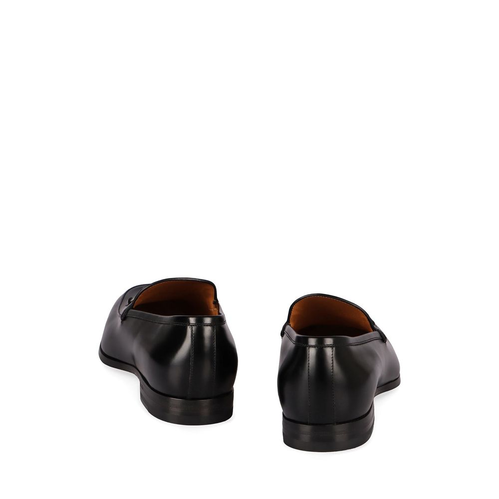 Mocassins Gucci en cuir de veau noir pour hommes, style slip-on avec finition élégante et semelle en caoutchouc.