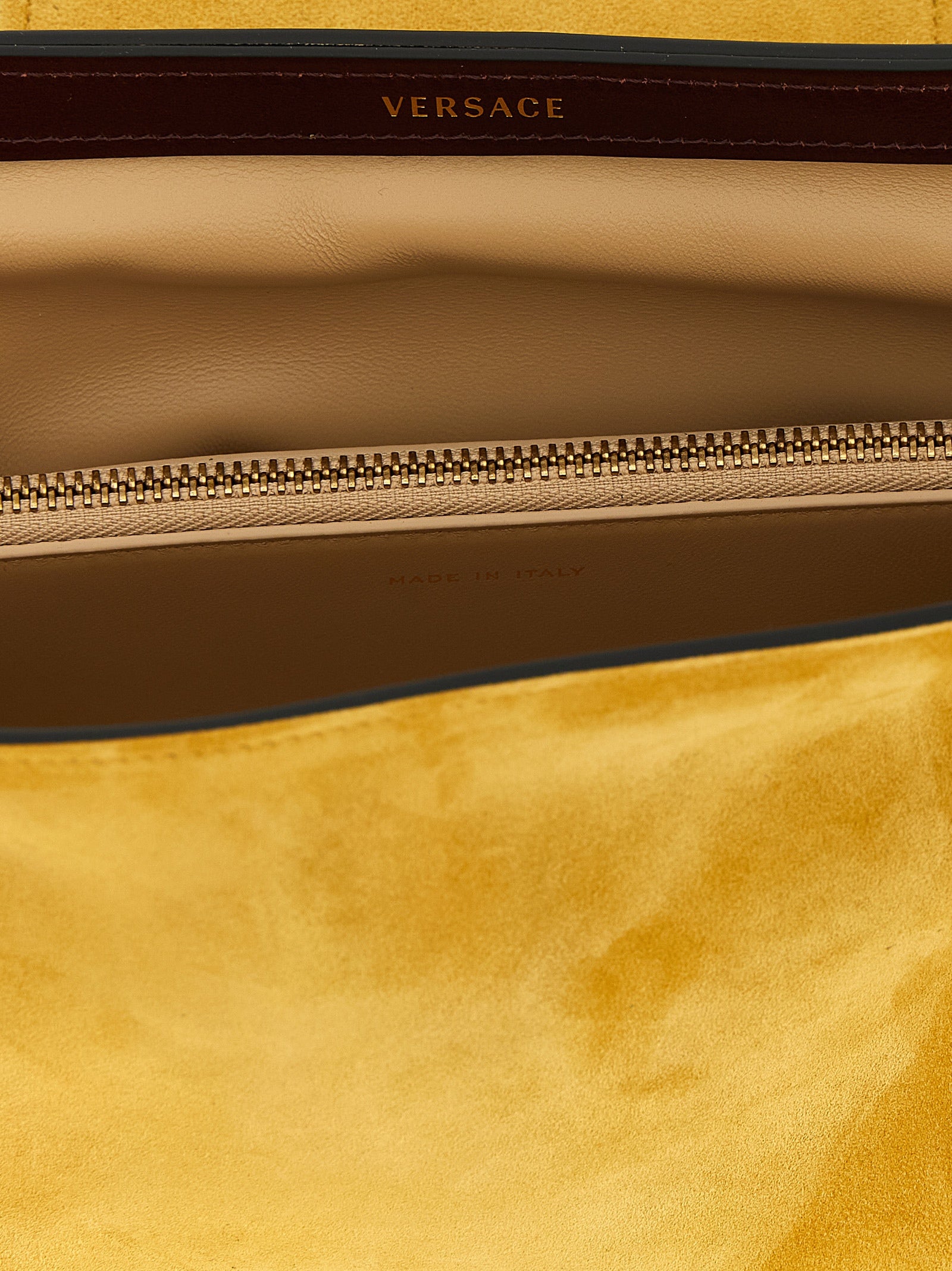 Sac clutch en cuir bicolore Versace, élégante pochette pour femme avec détails sophistiqués et logo emblématique.