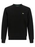 Sweat-shirt en coton noir de Lacoste avec logo crocodile vert, manches longues et coupe décontractée, porté en mode décontracté.