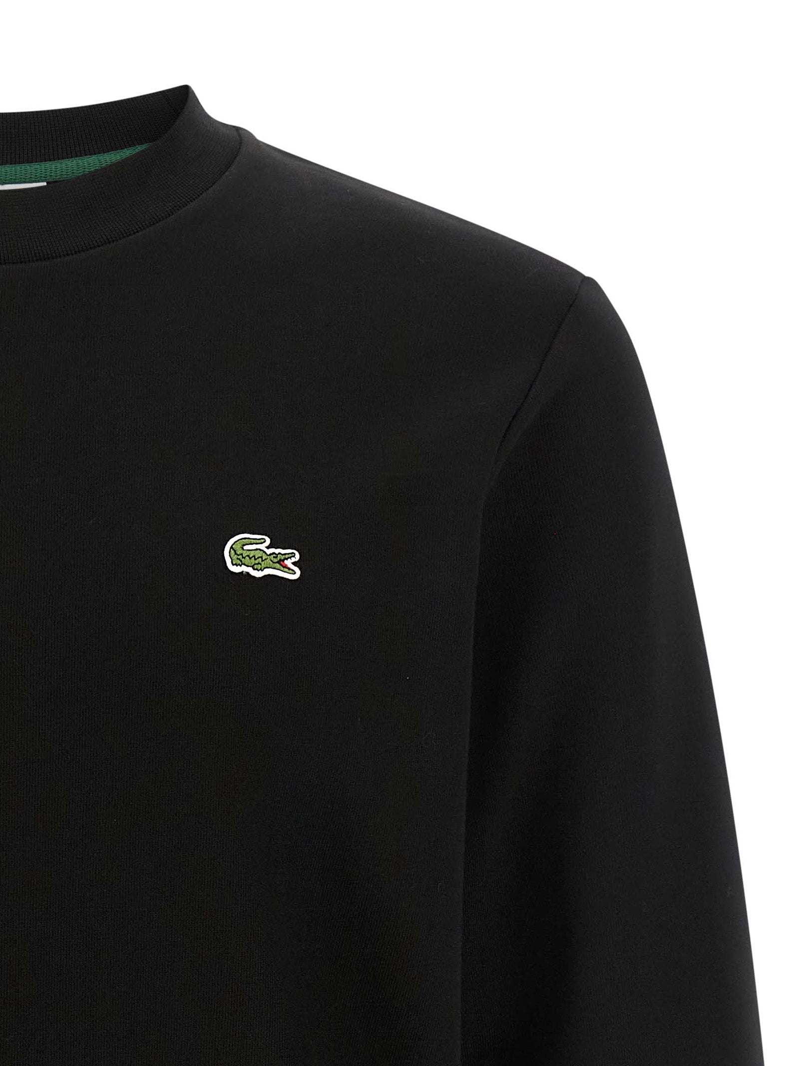 Sweat-shirt noir en coton de Lacoste avec logo crocodile brodé, manche longue, style décontracté et confort optimal.