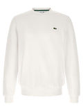 Sweat-shirt blanc en coton de marque Lacoste, avec logo crocodile sur la poitrine, porté sur un mannequin.