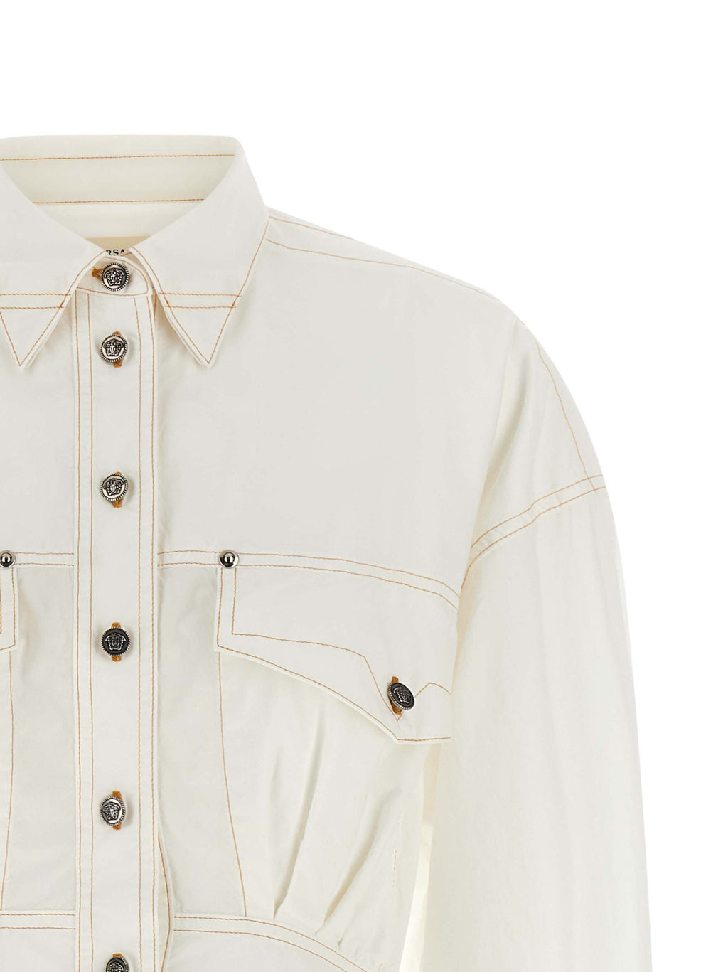Robe courte en coton blanc de Versace, élégante et légère, avec un design sophistiqué et des détails raffinés.