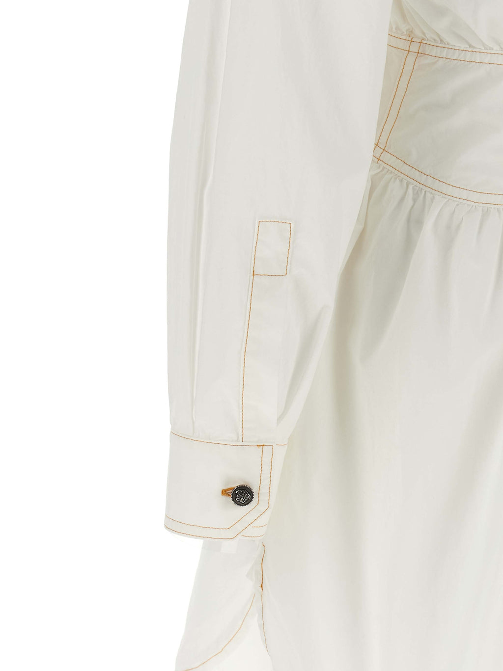Robe courte en coton blanc de Versace, élégante et légère, avec détails sophistiqués visibles sur l'image.