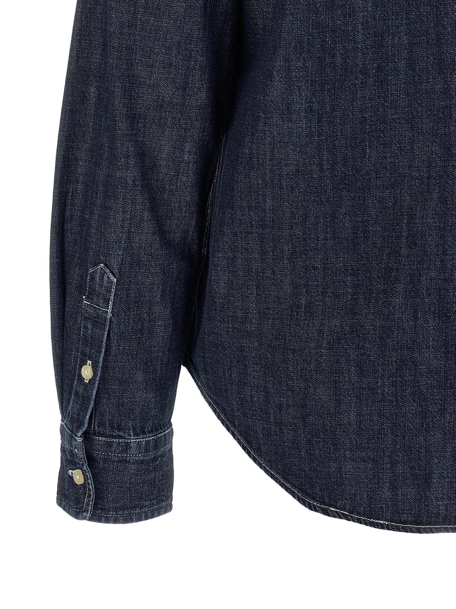 Chemise en coton bleu Polo Ralph Lauren, silhouette classique, col et boutons visibles, tissu doux et élégant pour un look décontracté.