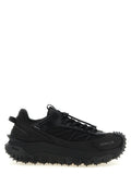 Chaussures de sport en cuir noir Moncler, baskets athlétiques élégantes avec design moderne et semelle robuste.